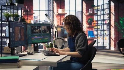 Woman video creator working on editing a movie montage project, multitasking with dual monitors. Female footage editor starting the cinematic creative process, film editing industry. Camera A.