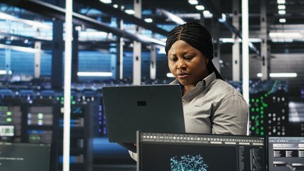 Data center computer scientists use node tree programming to identify equipment performance issues. Server farm employees review data analysis graphs to minimize infrastructure failures, camera B