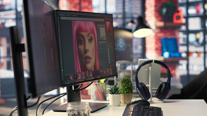 Inspiring creative workspace with professional editing software and AI chat bot open on a dual...
