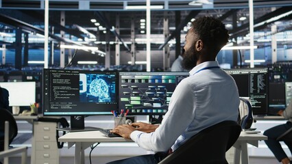 Data center programmer uses machine learning node tree program to identify equipment issues. Server hub worker reviewing artificial intelligence data analysis graph to minimize failures, camera A