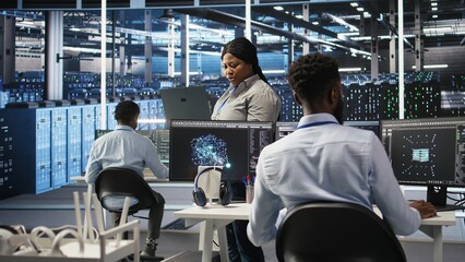 Data center computer scientists use node tree programming to identify equipment performance issues. Server farm employees review data analysis graphs to minimize infrastructure failures, camera A