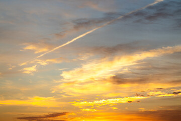 Dramatic golden hour sky with vibrant clouds.