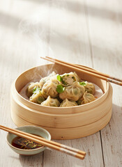 Steaming Fresh Dumplings in a Bamboo Steamer with Dipping Sauce and Chopsticks on a Rustic Wooden Table