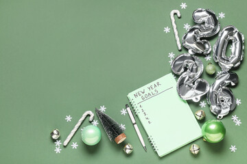 Notebook with to-do list, figure 2026 and Christmas decor on green background