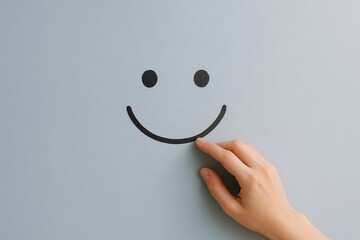 Smiling face icon with human hand on soft blue background. concept of positive symbolism, human connection, simple joy.