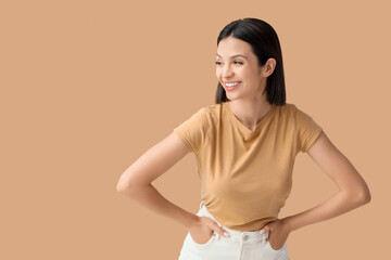 Obraz premium Beautiful young woman with short hair on brown background