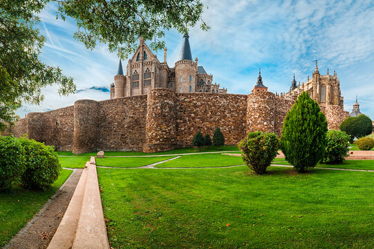 Green garden next to big ancient walls of Astorga city in Spain.
