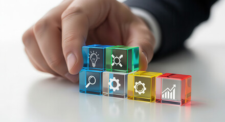 Innovation indicator cubes arranged by hand with sharp foreground detail and softly blurred white background