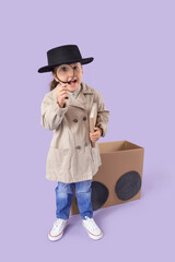 Fototapeta premium Cute little detective with adventure book and magnifier near cardboard car on lilac background