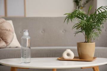 Bottle of water with time stamps on table in room, closeup