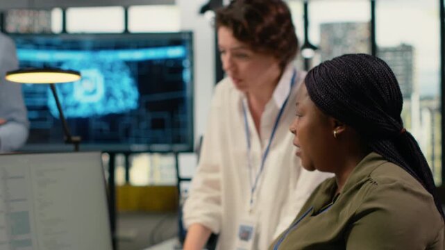 Technicians doing brainstorming in office, using specialized hardware to accelerate complex AI calculations. Teamworking colleagues managing systems for machine learning training datasets, camera B