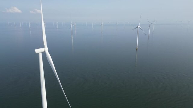 4K aerial view of an offshore windpark during calm weather, Breezanddijk, The Netherlands