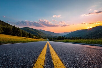 Stunning mountain landscape with beautiful asphalt road at sunrise