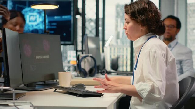 Scared admins in office panicked by alert, trying to stop hacker intrusion stealing sensitive data. Startup coworkers doing frantic incident response to network attack from cybercriminal, camera B