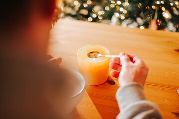 Fun tin casting set for New Years party.Tin spoon and tin figurines against a beautiful backdrop of garlands and a Christmas tree. 