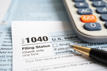 Tax Return form 1040 and dollar banknote, U.S. Individual Income.