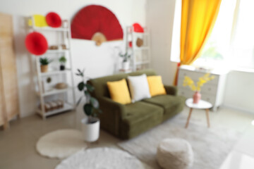 Interior of light living room with sofa, shelf units and decor for Japanese New Year celebration