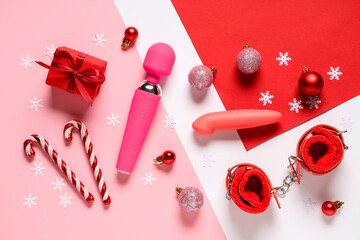 Obraz premium Composition with sex toys, gift box and Christmas decorations on color background