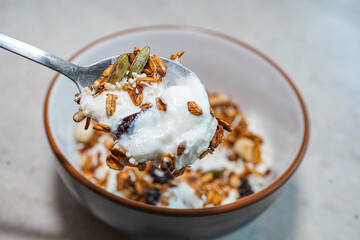 Spoon full of Greek yogurt granola breakfast