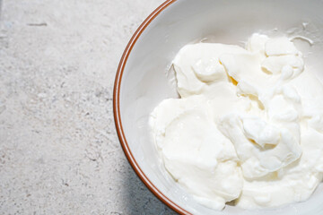 Creamy greek yogurt in white bowl for breakfast