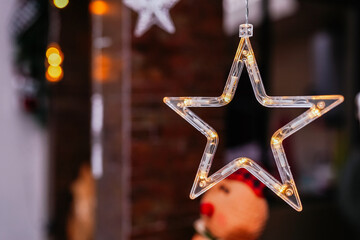 Illuminated Christmas star decoration hanging with bokeh lights