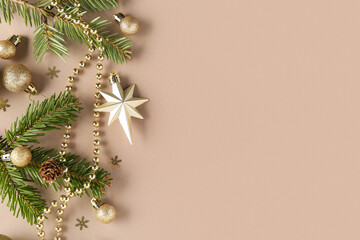 Christmas composition with fir tree branches and decor on beige background