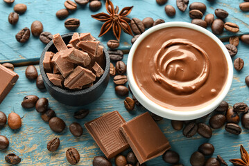 Composition with tasty melted chocolate on blue wooden background