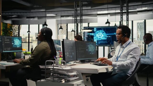 Startup programmers doing tech support, helping users fix errors during remote call. Helpdesk workers in workplace talking in headset mic, responding to service alerts, aiding customers, camera A