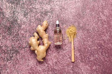 Bottle of ginger cosmetic oil and wooden spoon with dried powder on purple background