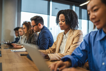 Diverse business professionals collaborating in modern office meeting