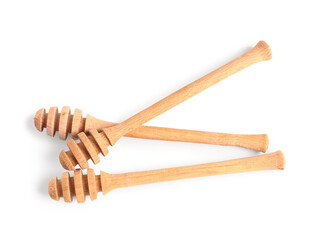 Wooden honey dippers isolated on white background