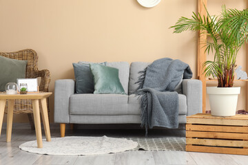 Interior of living room with cozy grey sofa and coffee table