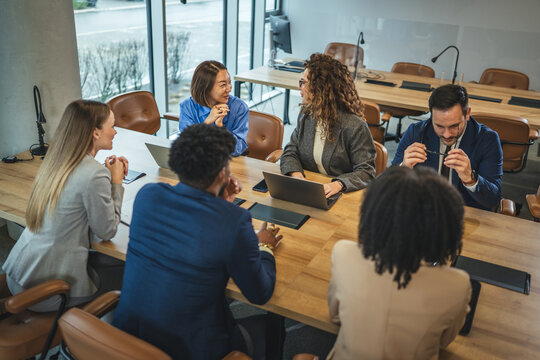 Diverse team collaborating during business meeting in modern office space