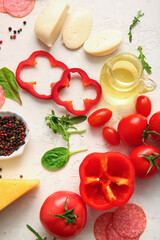 Different ingredients for preparing pizza on light background