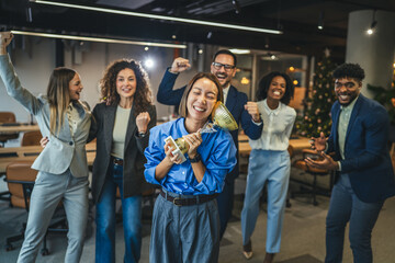 Diverse business team celebrating achievement receiving golden trophy award