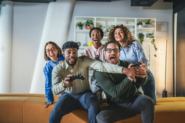 Obraz premium Diverse friends having fun playing video games together