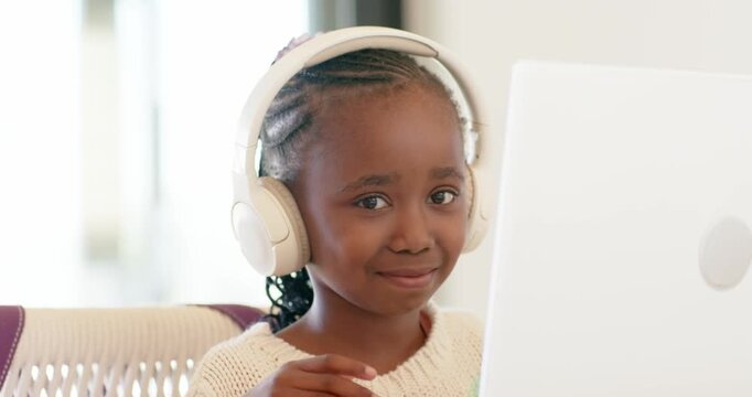 Notification pinging as African American girl typing on laptop and listening lesson through headset