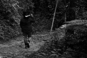 Obraz premium Young female wildlife photographer walking with camera in remote Himalayan village