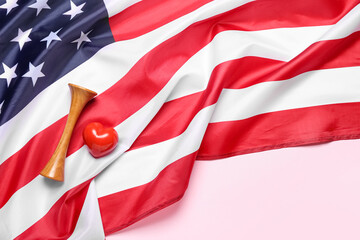 Stethoscope with heart and USA flag on pink background
