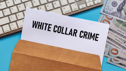 Document with "White Collar Crime" in a Brown Envelope on a Keyboard with Cash for Financial Investigation Concept