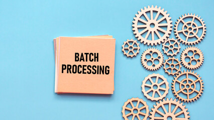 Note Card with "Batch Processing" Text Surrounded by Wooden Gear Wheels for Data Automation and System Workflow Concept
