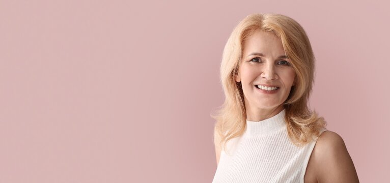 Stylish mature woman on pink background with space for text