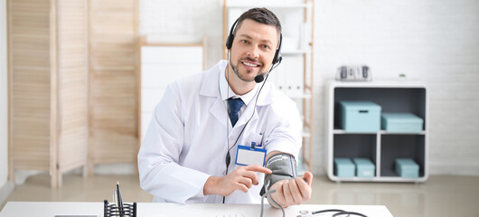 Male doctor giving a consultation online in clinic