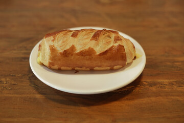 Golden brown baked pastry on wooden table