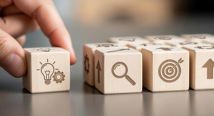 Wooden cubes featuring innovation scale icons positioned manually with controlled depth and gentle blurred background