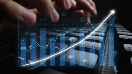 This image captures hands typing on a keyboard with an overlay of a financial growth graph, representing market analysis and business trends in a modern workspace. Copula
