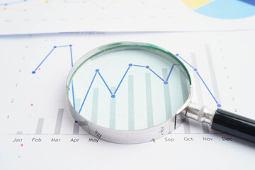Magnifying glass on charts graphs paper. Financial development, Banking Account, Statistics, Investment Analytic research data economy.