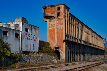Old industrial buildings next to abandoned railway