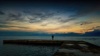 Sunset sea pier man phone