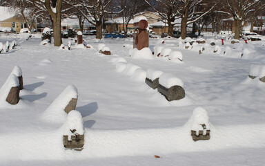 Rows of gravestones covered in snow at a small suburban Chicago cemetery